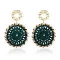 Detailed close-up of bohemian woven earrings with gold-tone and dark green thread design. - Green
