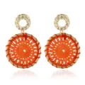 Detail shot of bohemian woven orange hoop earrings with gold hammered metal top studs. - Orange