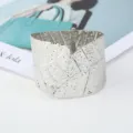 Wide silver leaf cuff bracelet for women, metallic open bangle fashion jewelry accessory. - Silver