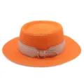 Detail view of the elegant orange straw hat featuring a chic beige leather belt and buckle. - M (56-58cm) / Orange