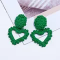 Green metal embossed heart earrings detailed view, stylish geometric drop earrings. - Green