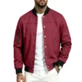 Detailed view of the burgundy suede bomber jacket showcasing contrast black ribbed trim and snap buttons. - S / Tops / Red