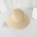 Vue détaillée d'un chapeau de paille élégant avec perles et ruban, accessoire de plage estival. - M (56-58cm) / Beige