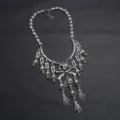 Detailaufnahme der gotischen Punk-Mehrschicht-Totenkopf-Quasten-Halskette mit Knochengliedern. - Silber