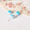 Close-up detail of blue glass smiley face polka dot beads with pins for DIY earrings. - Sky Blue