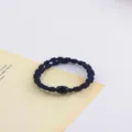 Detail view of a minimalist black elastic hair band with a chic cylindrical bead for daily styling. - Style 8 / 5 Pieces/Pack