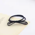 Detail view of a minimalist black elastic hair tie with a cute bow knot design for daily wear. - Style 2 / 5 Pieces/Pack
