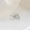 Close-up detail view of silver metal jump rings for DIY jewelry making accessories. - 5mm (50 Pieces/Pack) / Platinum