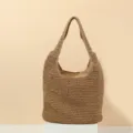 Detailed shot of the handmade crochet straw shoulder bag, showing close-up woven texture. - Solid Khaki