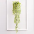 Artificial hanging plant detail view, featuring delicate yellow flowers and green cascading vines. - Large Yellow Green
