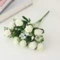 Detailed close-up of artificial white silk rose bouquet with small daisies for home decor. - White