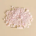 Close-up detail of 3mm jelly pink seed beads, perfect for DIY jewelry making and bracelets. - Style 08