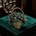 Close-up of a vintage gold flower basket brooch featuring sparkling black and clear rhinestones. - Flower Basket Style (B-4-1) / 4.1*4.4cm / Black