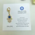 Pendentif breloque œil maléfique main de Hamsa dorée avec strass pour porte-clés et sac. - 27