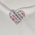 Detailed view of heart acrylic charm pendant featuring floral design and spanish quote. - Style 9