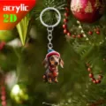 Detailed view of the cute dachshund Christmas acrylic keychain hanging on a festive tree. - Style 1