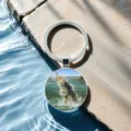 Closeup detail of fishing theme keychain with glass time gem pendant and fish pattern. - Style 2