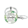 Detailed close-up of the metal keyring pendant featuring clear glass and inspirational quote. - Style 2