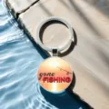 Detailed view of fishing theme glass cabochon keychain, sunset bait design with metal ring. - Style 3
