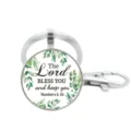 Zilveren metalen sleutelhanger met glazen hanger, groene bladeren en inspirerende religieuze tekst. - Stijl 5