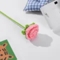 Handmade crochet wool pink rose with green stem, perfect for home decor and floral arrangement. - Deep Pink
