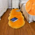 Soft fluffy faux fur bedside rug detail, golden camel long plush carpet for living room bedroom. - Turmeric