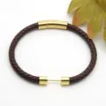 Detailed view of braided brown leather bracelet featuring golden stainless steel magnetic clasp. - Style 6