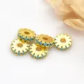 Close-up detail of gold-plated gear spacer beads with blue details for DIY jewelry making. - Turquoise
