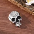 Close-up of vintage silver skull brooch with clear rhinestones and black enamel details. - Crown Skull (Antique Silver) (A-1-4)