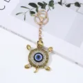 Evil eye turtle keychain, fashion rhinestone blue eye keyring, unique backpack pendant accessory. - 1 Piece / White