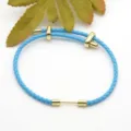 Blue braided leather bracelet with gold metal dumbbell charm, stylish DIY jewelry accessory. - Blue