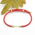 Red braided leather cord bracelet with gold metal accessories, stylish DIY jewelry accessory. - Red