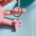 Pink heart keychain with cute eye and flower motifs, rose gold alloy metal detail. - Style W