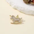 Exquisite gold rhinestone unicorn rocking horse brooch detail view with sparkling crystal stones. - Pony
