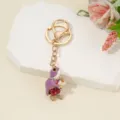 Detailed close-up view of a sparkling rhinestone animal alloy keychain pendant display. - Purple Enamel Turtle / 10.2*2.1cm / Purple Enamel