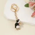 Close-up detail of the cute rhinestone penguin keychain with gold hardware and metal ring. - Black Enamel Turtle / 10.2*2.1cm / Black Enamel Style