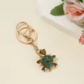 Detailed shot of a charming rhinestone turtle keychain with sparkling blue stones on gold metal. - Full Rhinestone Green Turtle / 10*3.1*1.1cm / Rhinestone Green