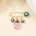 Elegant gold tone safety pin brooch featuring blue evil eye charms and pink ladybug pendant. - Pink Beetle Style (2)