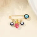 Broche épingle de sûreté dorée ornée de perles mauvais œil et d'un pendentif fruit du dragon. - Style Pitaya / 3.8x2.8cm