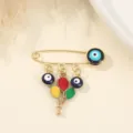 Gold evil eye safety pin brooch featuring colorful balloon charms, sweet fashion jewelry accessory. - Colorful Balloon and Evil Eye Style