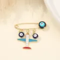 Close-up detail of the creative evil eye airplane brooch, showcasing fine enamel craft. - Airplane and Evil Eye Style