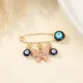 Gold-tone alloy safety pin brooch featuring blue evil eye beads and pink enamel butterfly charms. - Triple Evil Eye Butterfly Style (8)