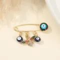 Gold tone safety pin brooch featuring evil eye beads and crystal bee detail detail shot. - Enamel Bee Style (9)