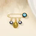 Broche œil maléfique en or avec fruits uniques et pendentifs yeux bleus pour femmes. - Style Durian / 3.8x2.8cm