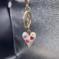 Alloy enamel heart keychain detail showing colorful doodle pattern and gold tone metal rings. - Style J