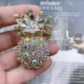 Close-up detail of the luxury crystal rhinestone pineapple brooch sparkling alloy jewelry piece. - 6.3*4cm / White