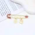 Gold-tone safety pin brooch with pink rhinestones, crown charm, and Arabic calligraphy details. - Crown Red Rhinestone Pin (A#H02) / 2.1x7.2cm
