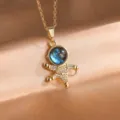 Close-up detail of the gold astronaut pendant necklace with sparkling zirconia and galaxy dome. - Crossing Astronaut Style (ZPN535C)