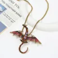 Detailed close-up of a vintage enamel dragon pendant necklace featuring sparkling crystal accents. - Dual Use Necklace Brooch / Size 8.8x7.6cm Chain 52cm / Coffee