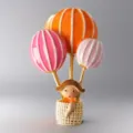 Close-up detail of the colorful hot air balloon brooch, featuring enamel finish and gold lines. - 9.3*5.7cm / Orange Red